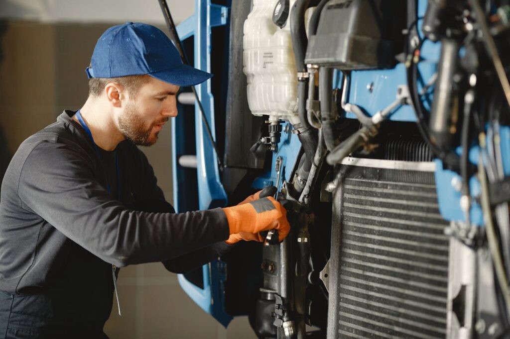 Mechanic repairing a machine with precision, showcasing industrial expertise.